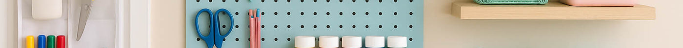 Colorful craft room with cheap vertical storage ideas using pegboards, baskets, and DIY shelves to organize supplies in a small space.