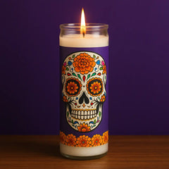 Lit Día de los Muertos candle in glass holder with sugar skull and marigold design, ideal for Day of the Dead altars, incense rituals, and spiritual remembrance.