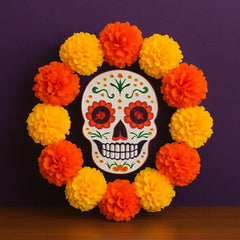 Day of the Dead wreath with marigold flowers and sugar skull centerpiece, perfect floral decor for Día de los Muertos altars, doors, and celebration spaces.