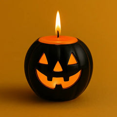 Black ceramic pumpkin candle holder with glowing orange candle, perfect for Halloween mood lighting, spooky ambiance, and festive fall home decor.