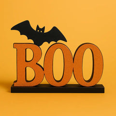 Halloween tabletop decor featuring a glittery orange "BOO" sign with a black bat perched on top, perfect for spooky centerpieces and seasonal home displays.