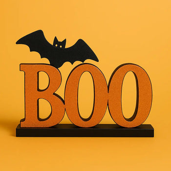 Halloween tabletop decor featuring a glittery orange "BOO" sign with a black bat perched on top, perfect for spooky centerpieces and seasonal home displays.