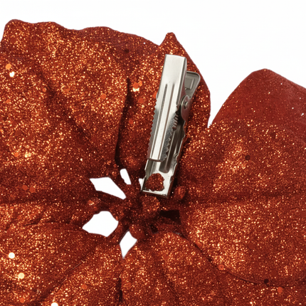 Close-up of Ashland clip-on poinsettia floral accent showing red poinsettia petals with gold glitter detail and clip mechanism