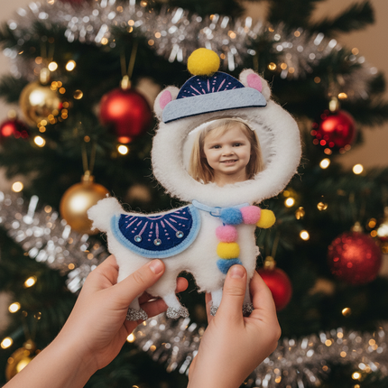 Child holding felt llama Christmas ornament showing circular photo frame insert