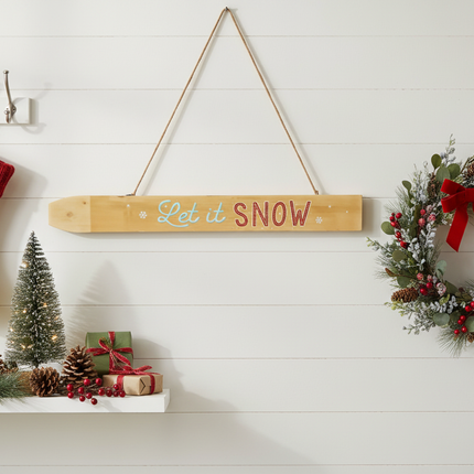 Rustic Let it SNOW wood sign hung on white shiplap wall with winter holiday decor