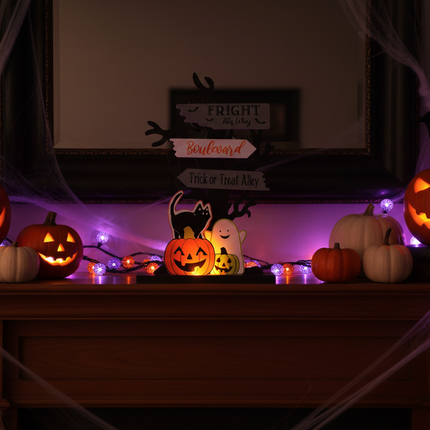 Ashland electric Halloween tabletop decor 6.25 inch glowing lit up on a mantel with pumpkins and Halloween decorations