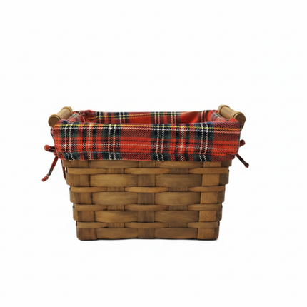 Rectangular woven wicker Christmas basket with small side handles and red tartan plaid liner on white background
