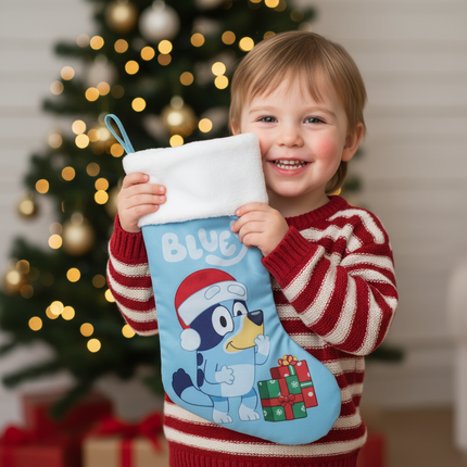 Child holding Bluey Christmas stocking 18in with Christmas tree bokeh background