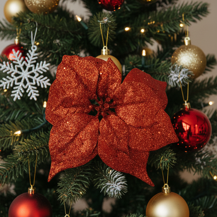 Ashland clip-on poinsettia floral accent clipped onto a Christmas tree branch among ornaments and lights