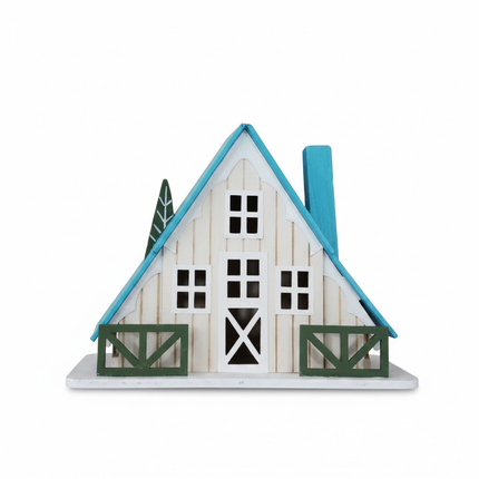 White A-frame cottage tabletop decor with teal roof and green fence accents on white background
