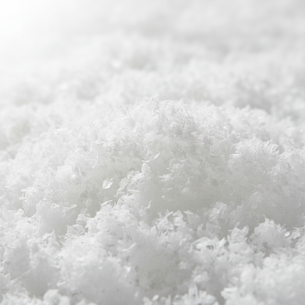 Close-up of fluffy white artificial fake snow texture showing realistic snow-like appearance