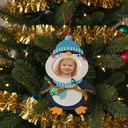 Studio Decor Felt Penguin Photo Ornament hanging on decorated Christmas tree