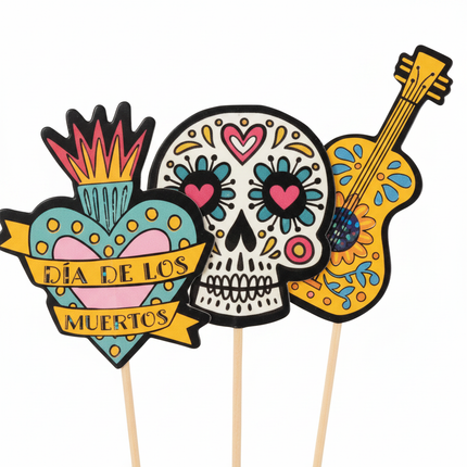Close-up of Celebrate It Dia de los Muertos cupcake toppers showing colorful sugar skull heart and guitar designs
