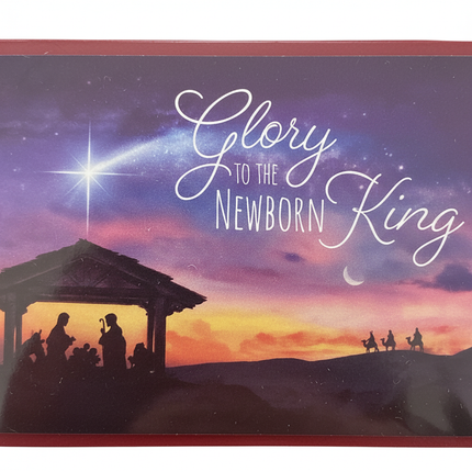 Close-up of Glory to the Newborn King Christmas card showing Nativity manger silhouette under glowing Star of Bethlehem against purple and gold sunset sky