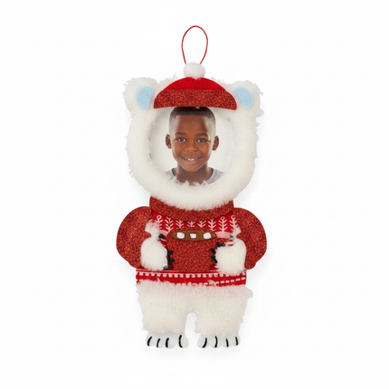 Close up detail of felt polar bear ornament red glitter Santa hat and circular photo frame
