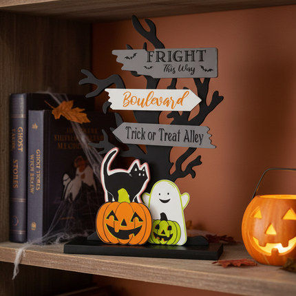 Ashland electric Halloween tabletop decor 6.25 inch on a bookshelf next to Halloween books and a small jack-o-lantern