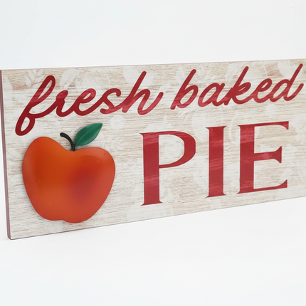 Rustic wood-look tabletop sign with red fresh baked PIE lettering and 3D apple accent on white background