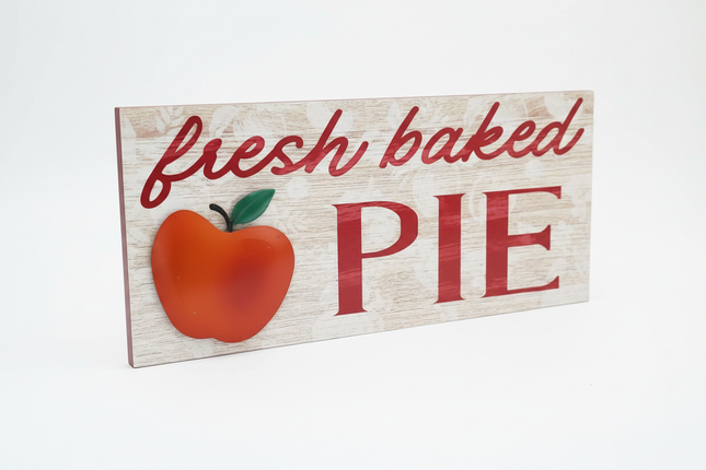 Rustic wood-look tabletop sign with red fresh baked PIE lettering and 3D apple accent on white background