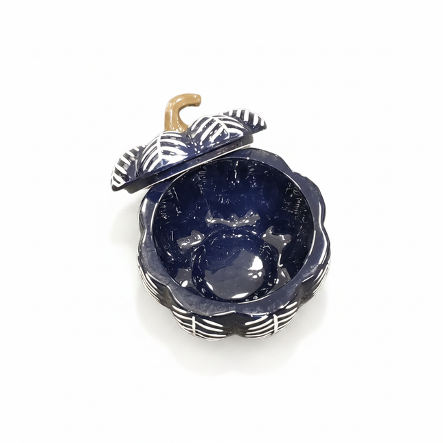 Celebrate It navy blue pumpkin-shaped ceramic bowl with black and white striped leaves and tan stem on white background