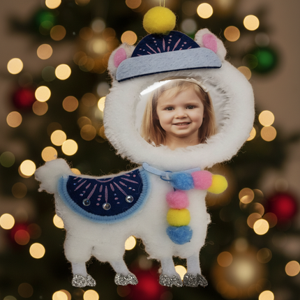 Close up of felt llama ornament showing blue gem saddle and colorful pom-pom scarf detail