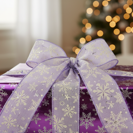 Celebrate It wired purple snowflake ribbon draped on a wrapped Christmas gift with purple and silver wrapping paper