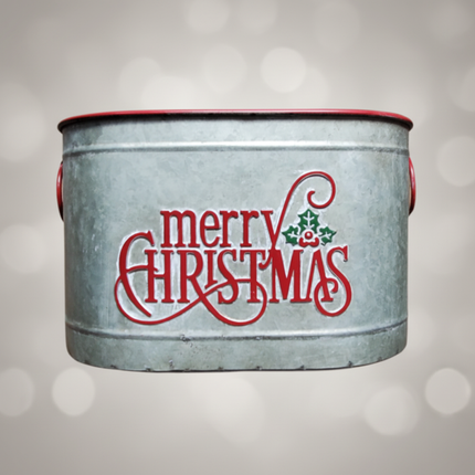 Close-up of Merry Christmas galvanized metal bucket showing red lettering and holly berry detail